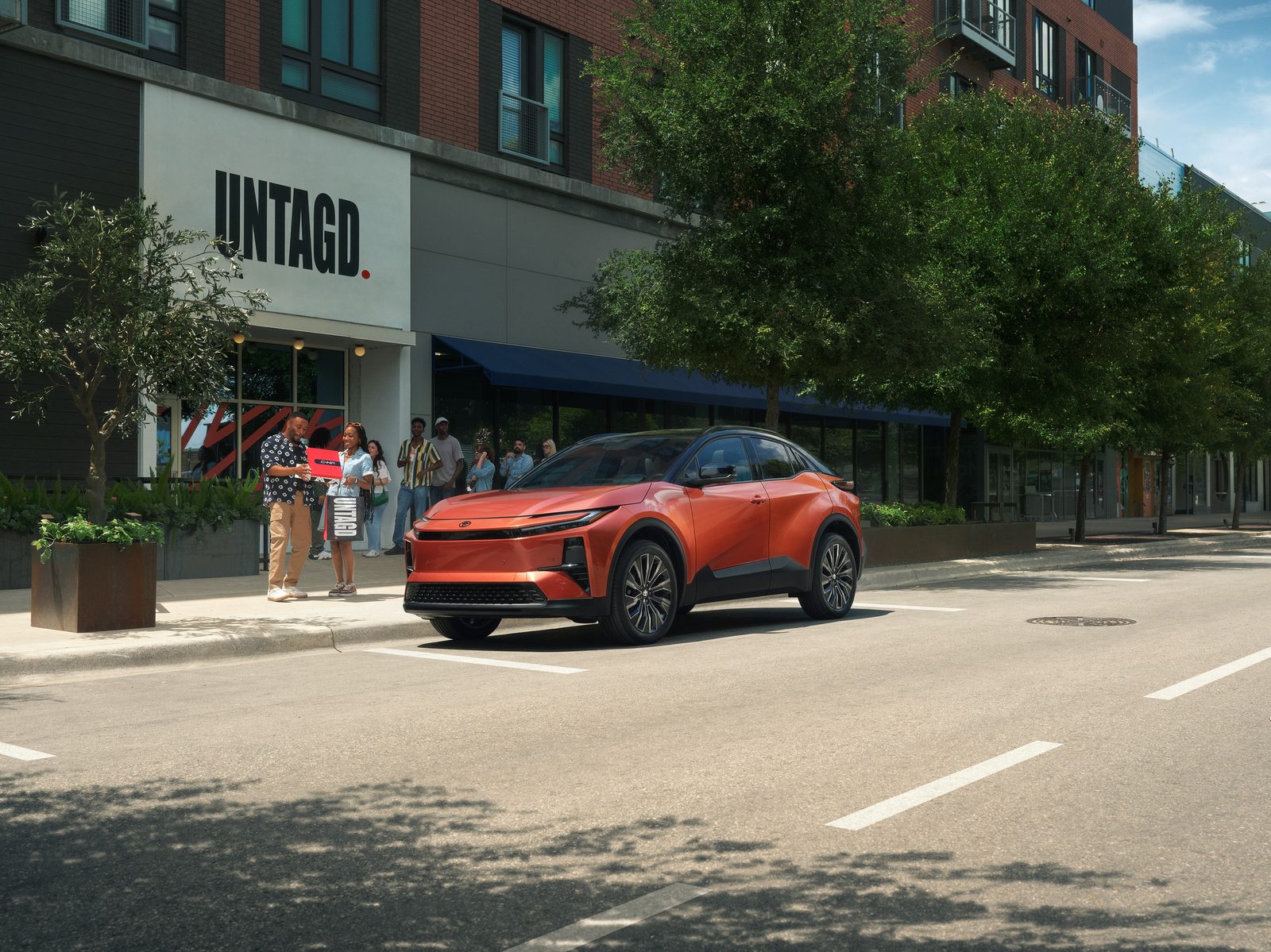 Toyota C-HR EV 2026 — экстерьер, two car motion, рынок US / EU reference